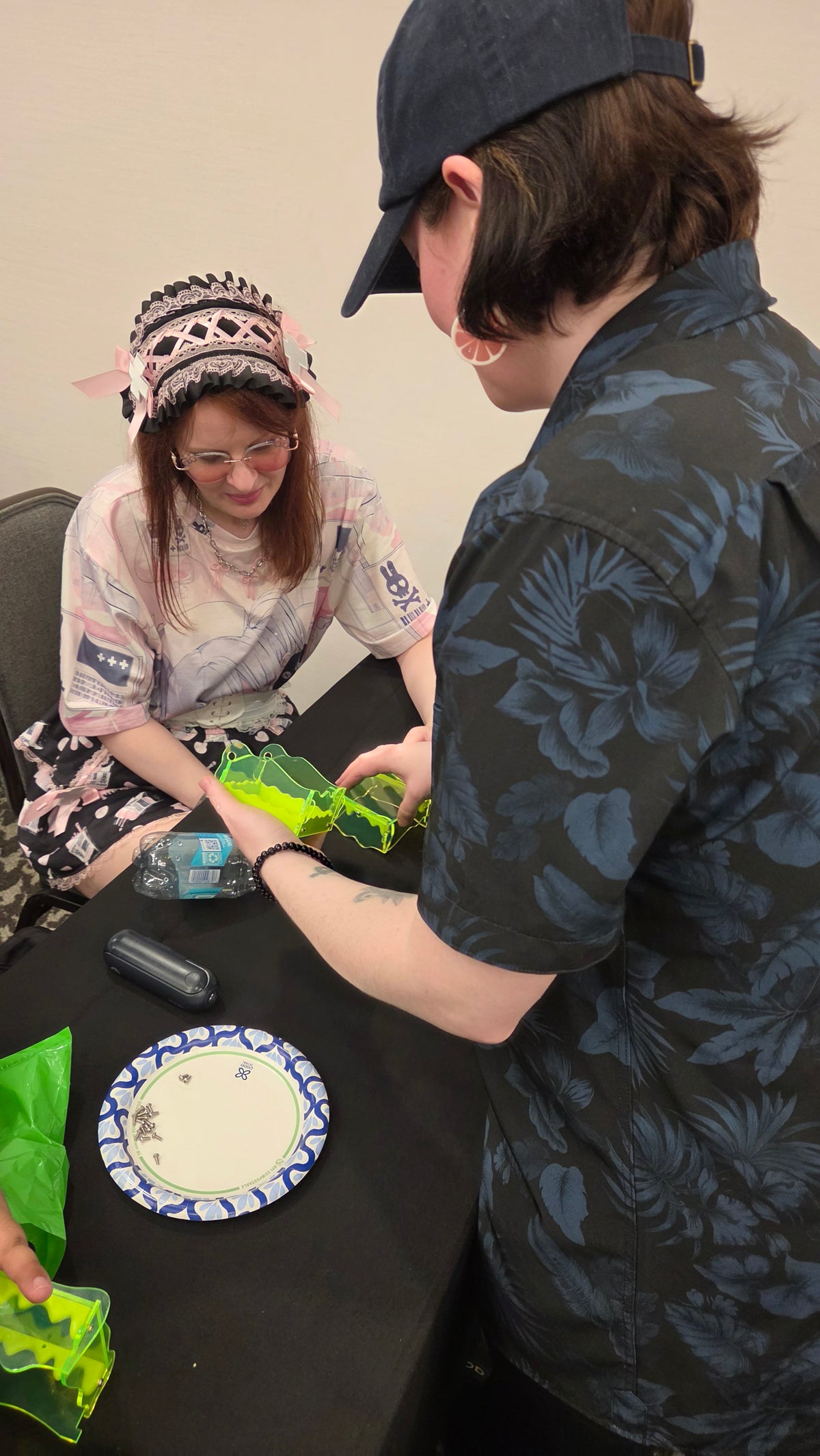 Class runner Emily Key helps to guide a participant through making sure that the top and bottom halves of the box are connected together at the hinge point.