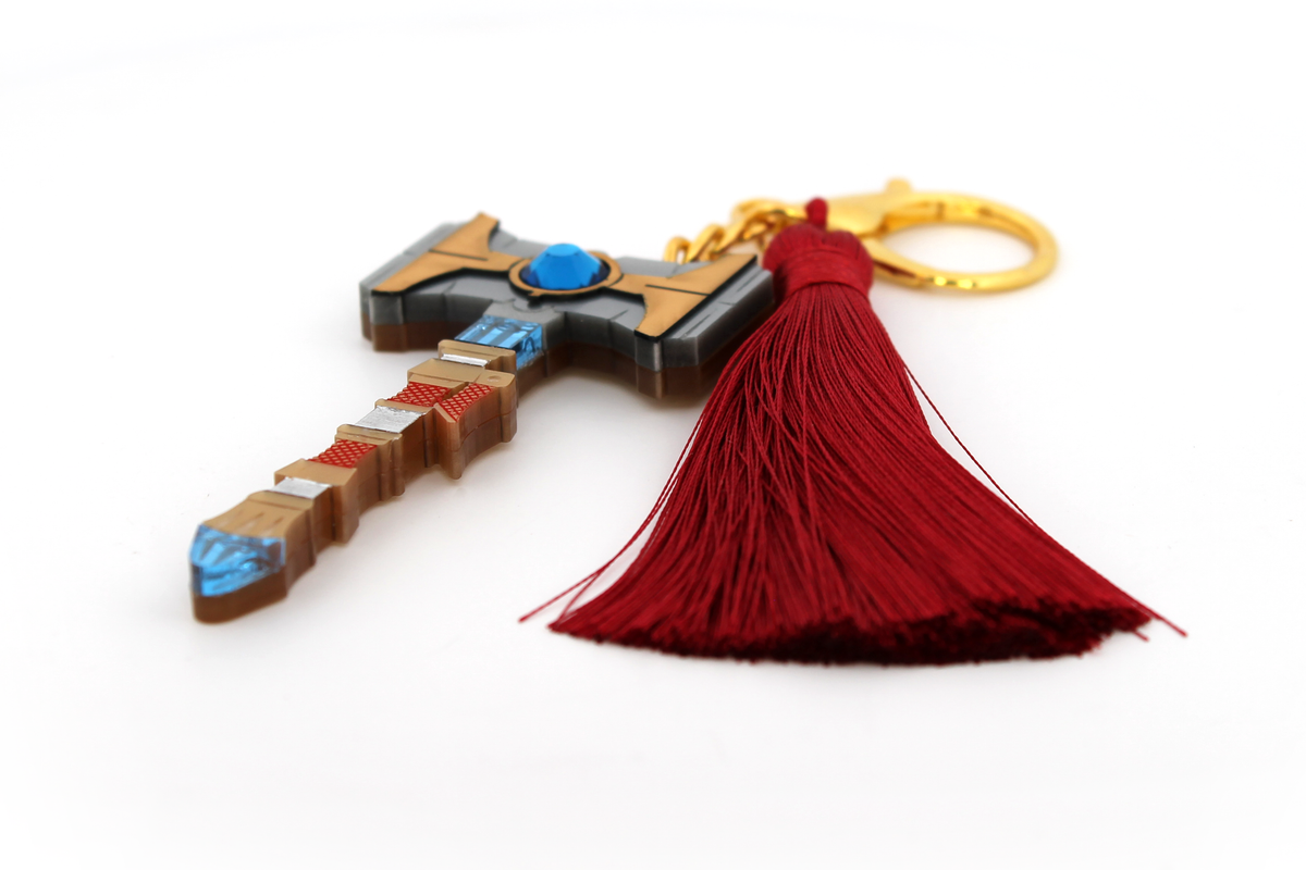 Talis Hammer bag charm created with multiple pieces of laser cut acrylic. Featuring etched mirror and metallic acrylic, hand inked and hand painted details along with a Swarovski crystal gem and red satin tassel.
